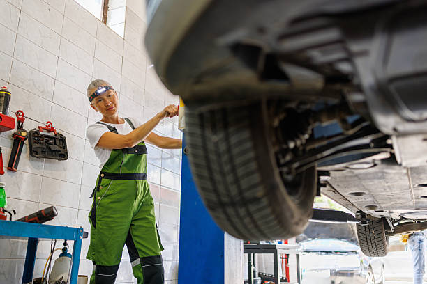 istock Modern Car Workshop with Vehicle Hoist in Use 2220288926