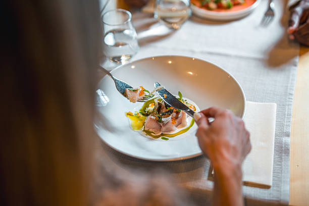istock Elegant Fine Dining with Exquisite Dish and Person Enjoying Gourmet Experience 2220290301
