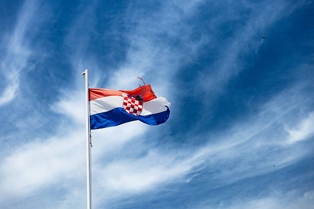 istock Croatian Flag and Deep Blue Sky with Clouds 2220292468