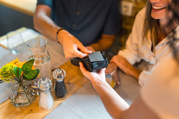 istock Contactless Card Payment Transaction At Restaurant Table With Fresh Table Decorations 2220292688