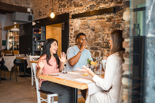 istock Diverse Couples Enjoying Animated Conversation At Rustic Restaurant With Exposed Brick Walls 2220292707
