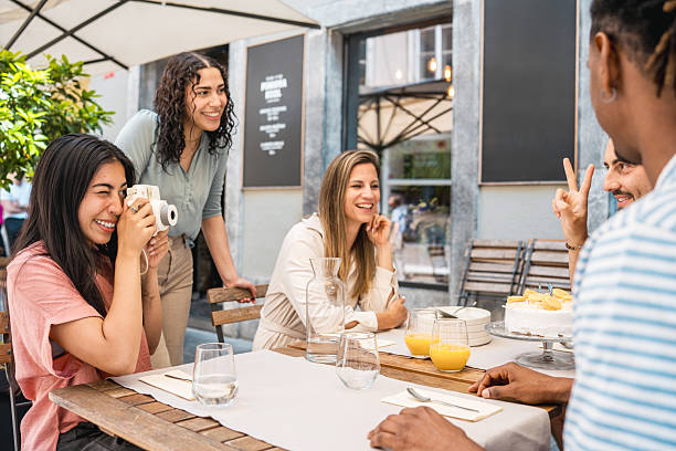 istock Diverse Friends Enjoying Outdoor Fine Dining in a Bright and Cheerful Setting 2220292740