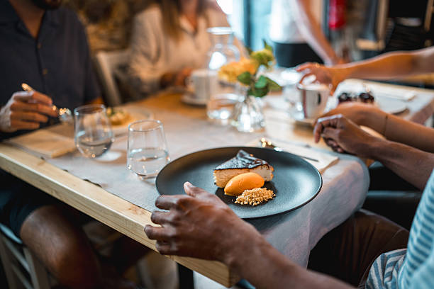 istock Elegant Dessert Plate With Orange Sorbet On Dark Ceramic Dish At Restaurant Table 2220292742
