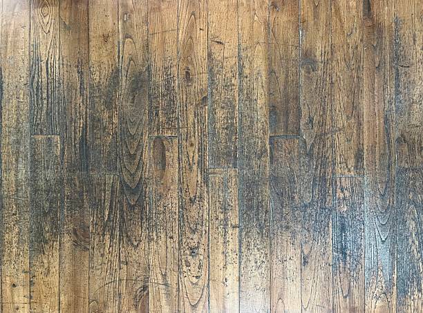 Rustic wooden floorboards showcasing aged texture and natural patina, perfect as a background or design element for projects emphasizing vintage and natural aesthetics.