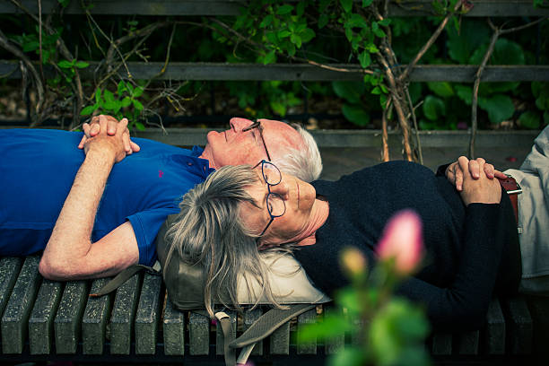 Couple sitting on porch swing. Old man and woman, evening.