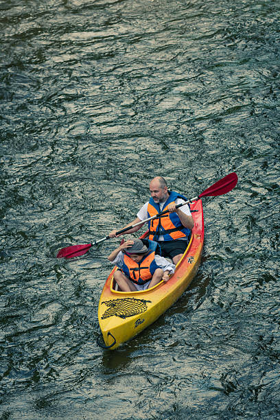Wittelsbacher Bridge, Munich, Bavaria, Germany, June 2003, a young man 15 or 16 years of age, practicing freestyle kayaking in a wave at high water of the Isar in the middle of Munich