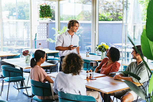 istock Diverse Friends Enjoy Restaurant Gathering with Laughter 2220301335