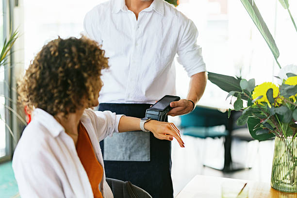 istock Customer Using Smartwatch to Pay Bill in Restaurant 2220301399