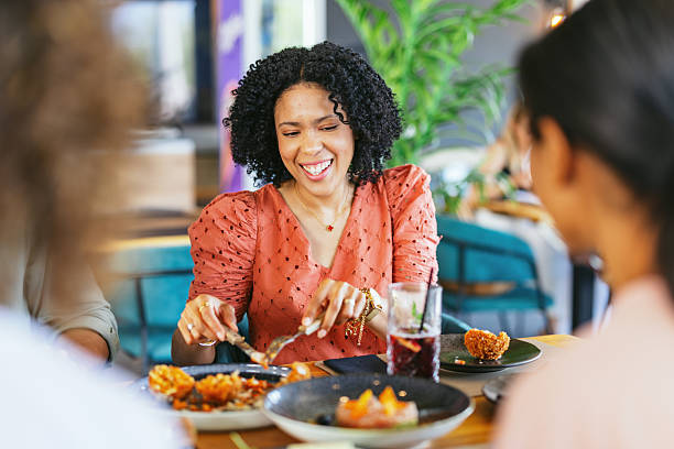 istock Friends Enjoying a Meal Together in a Restaurant Setting 2220301432