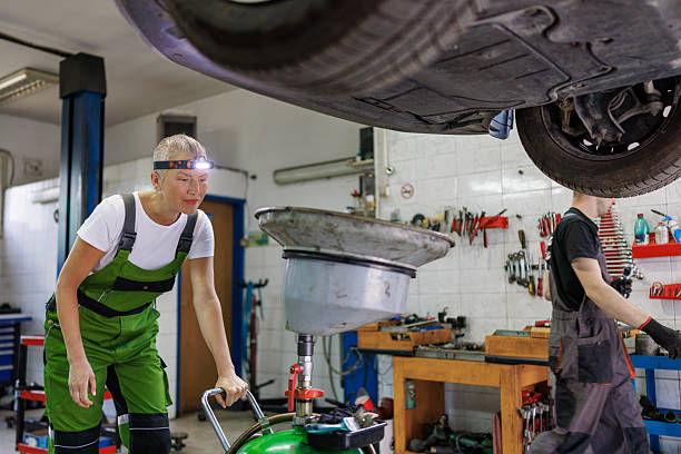 istock Car Maintenance by Female Auto Technician in Workshop 2220302024