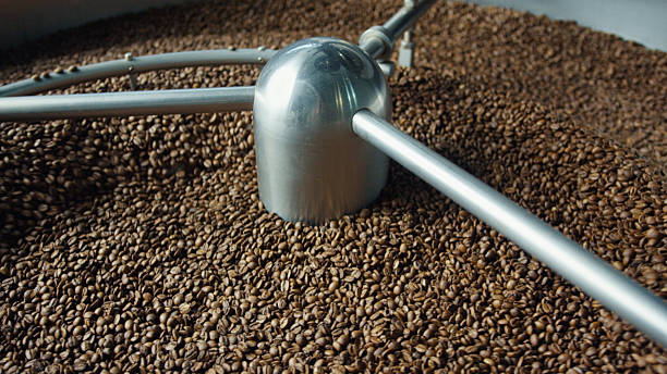 istock Coffee beans roasting in a large industrial machine 2220307732