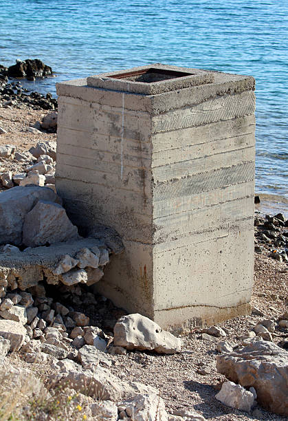 istock Weathered concrete utility block by the water 2220309602