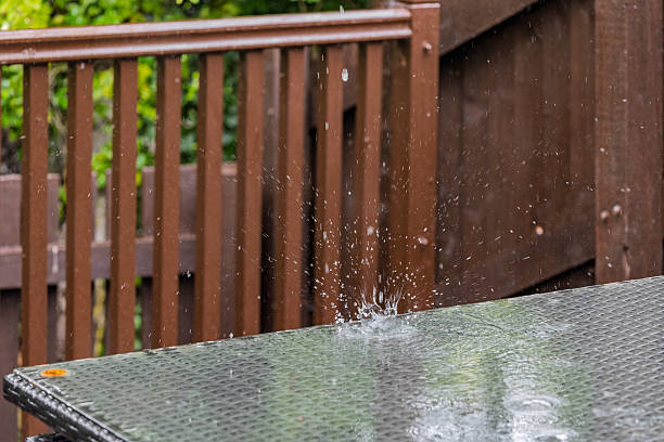 istock Dramatic raindrop creates a crown-like splash on a wet glass patio table due to heavy rain. Evokes the feeling of a downpour, due to climate change - High Angle 2220311358