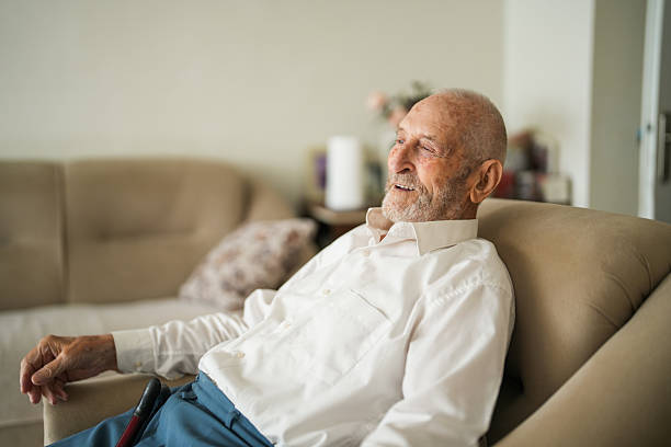 istock Senior Man Relaxing at Home and Smiling at the Camera 2220312052