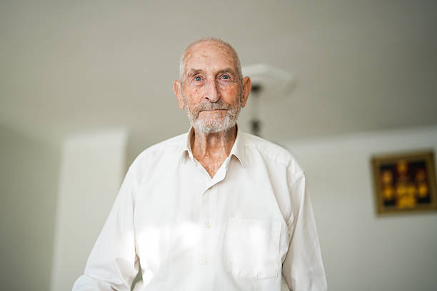 Elderly Man Walking with Cane in Living Room
