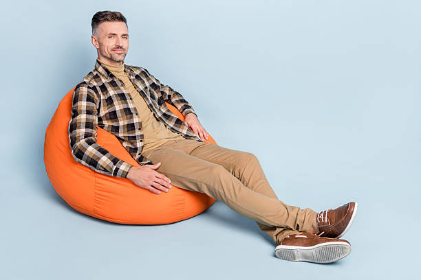 istock Full size profile side photo of young man weekend rest bean bag open space office isolated over grey color background 2220312311