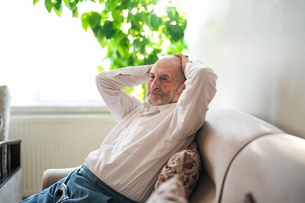 istock Lonely Elderly Man Sitting Thoughtfully at Home with Walking Cane 2220312937