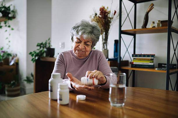 istock Senior woman taking medication at home 2220314003
