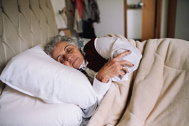 istock Senior woman sleeping peacefully in bed 2220314030