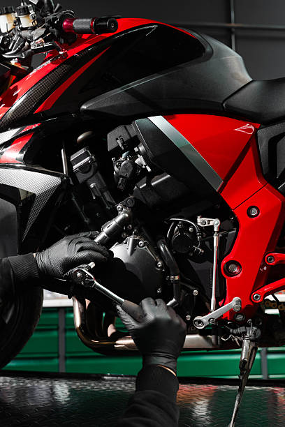 istock Motorcycle crankcase inspection with ratchet wrench ensures performance efficiency. Mechanic working on motorcycle crankcase during full maintenance inspection. 2220314316