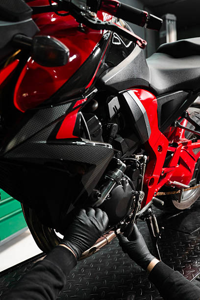 istock Mechanic working on motorcycle crankcase during full maintenance inspection. Motorcycle crankcase inspection with ratchet wrench ensures performance efficiency. 2220314334