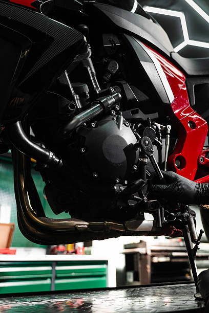 istock Motorcycle crankcase inspection with ratchet wrench ensures performance efficiency. Mechanic working on motorcycle crankcase during full maintenance inspection. 2220314342