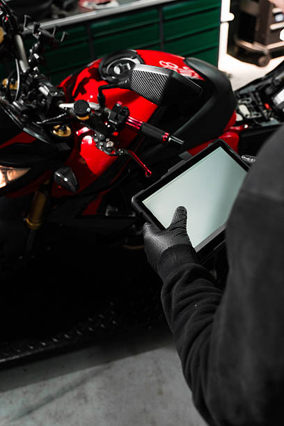 istock Mechanic performing system diagnostics via tablet. Motorcycle system diagnostic, scanning for faults across engine, electrical, and sensor modules to ensure reliability. 2220314397