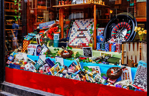 Cambridge, Massachusetts, USA - June 14, 2025:  View through a Harvard Square retail store display window of an assortment of games, amusements and trinkets. Leavitt & Peirce is a Harvard Square tobacconist open since 1883. They now sell non-tobacco related merchandise such as top-shelf toiletry items and classic board games.