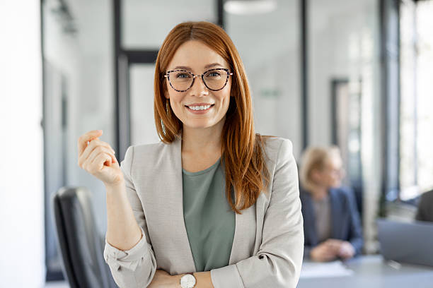 istock Young professional woman smiles while checking her phone 2220319047