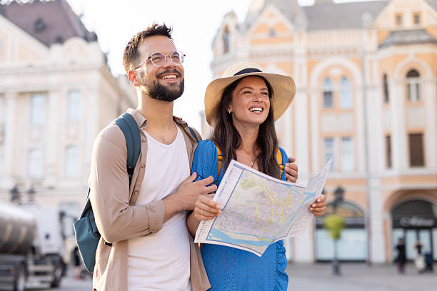 istock Smiling couple with a map, discovering the vibrant city space. 2220320016