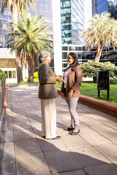 istock Two businesswomen having a conversation in a corporate outdoor setting 2220320127