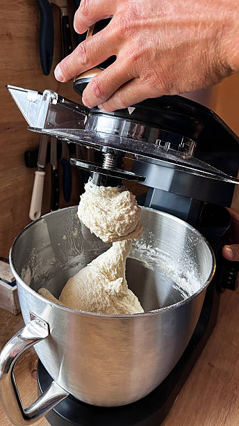 istock Men's hand opening food processor, after finishing kneading dough for bread or cake. 2220324887
