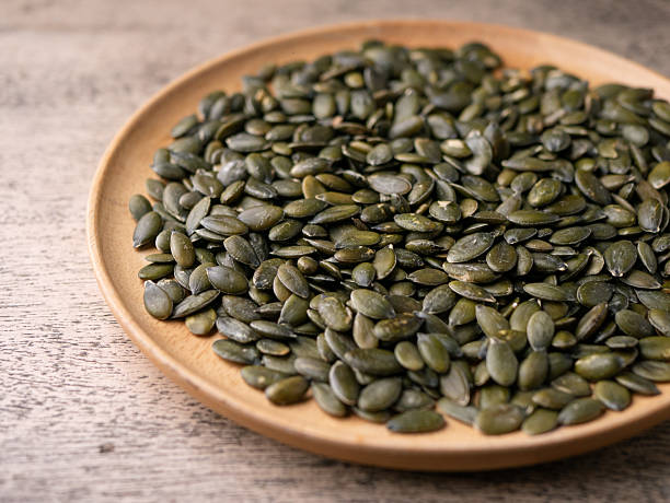 istock Peeled dry pepita pumpkin seeds background. 2220338917