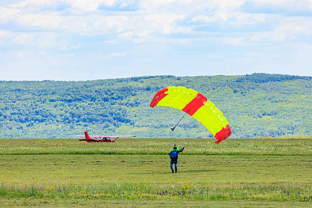 Skydiver landing in open field with bright parachute. May 31, 2025 Vadul lui Voda Moldova.