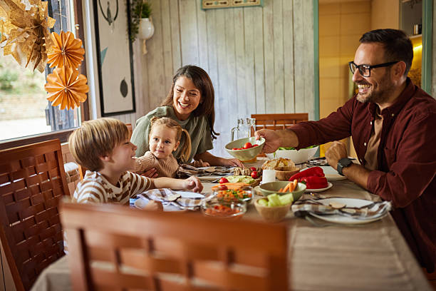 istock Happy parents having a meal with their kids at dining table. 2220344593