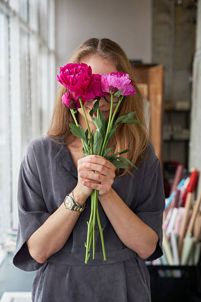 istock Woman with peony flower bouquet 2220344616