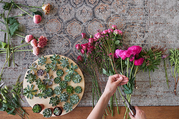 istock Female hands arranging fresh flower bouquet 2220344629