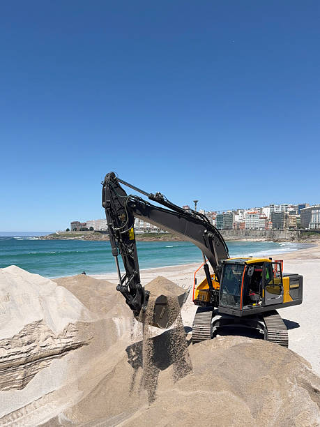 istock Excavator working on the beach on a sunny day 2220347412
