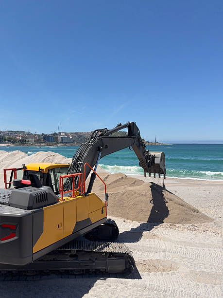 istock Excavator working on a sandy beach on a sunny day 2220347419