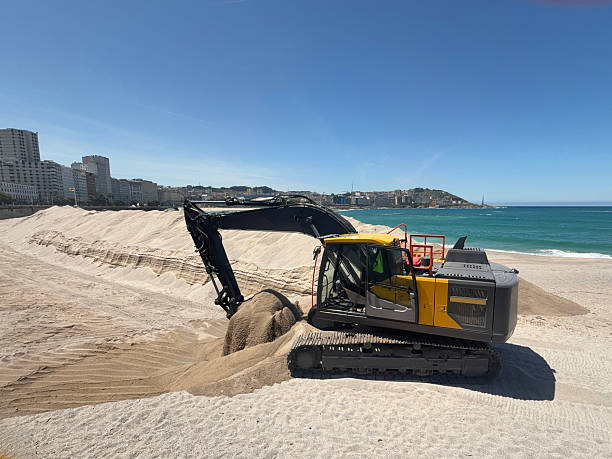istock Excavator arranging sand on the beach in a sunny day 2220347425