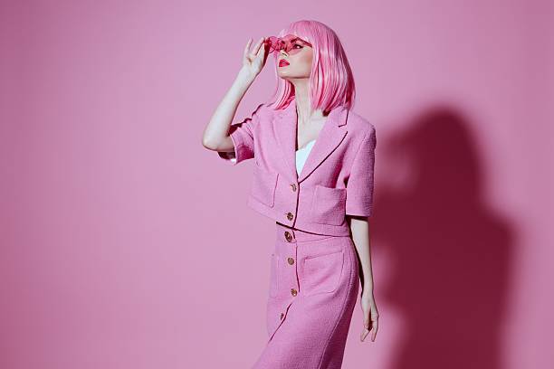 istock Pretty young female gesturing with hands pink jacket lifestyle glamor Studio Model unaltered 2220347999