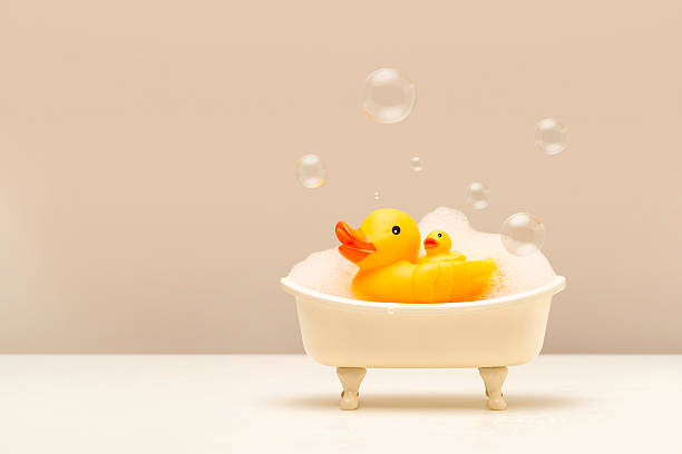istock Parenting and Bath Time Concept made with Rubber Duck Family in Mini Bathtub with Foam and Bubbles in Cozy, Joyful Atmosphere. Studio Photography with Copy Space. 2220348708