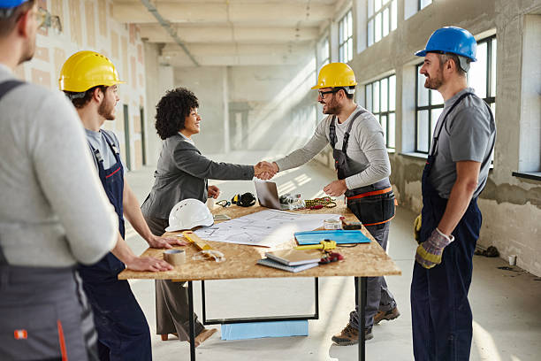 istock Happy female architect came to an agreement with workers at construction site. 2220351174
