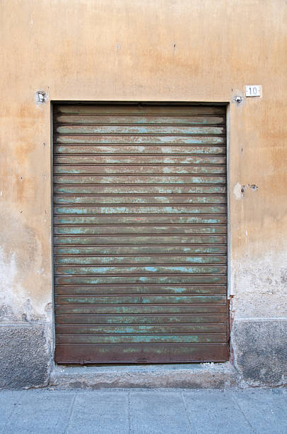 istock Old rusty iron gate once used to close the shop 2220353208