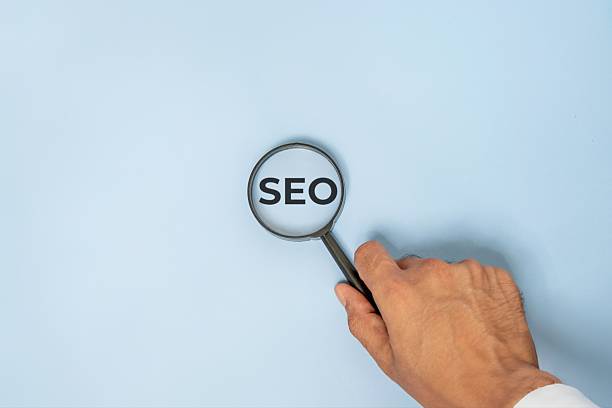 istock A magnifying glass with the letters SEO. 2220353285