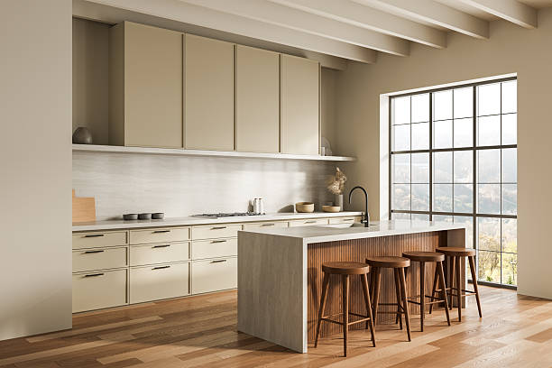 istock Modern beige kitchen interior with minimalist cabinets, large island, wooden stools and panoramic window in warm natural tones and bright daylight. 3D Rendering 2220355094