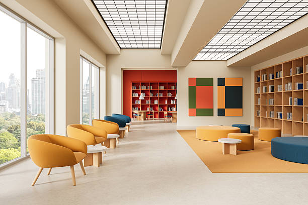 istock Modern library interior with colorful seating, large bookshelves, and panoramic city view through tall windows. Contemporary open reading space design. 3D Rendering 2220355304