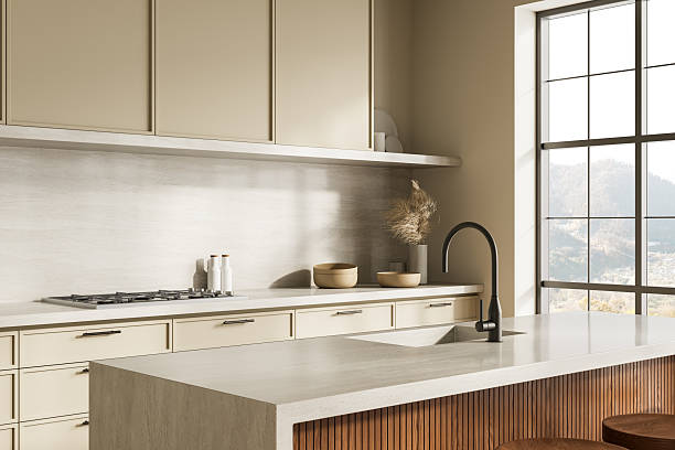 istock Modern minimalist kitchen interior with beige cabinets, large window, and neutral tones creating a serene natural atmosphere bathed in daylight. 3D Rendering 2220356045