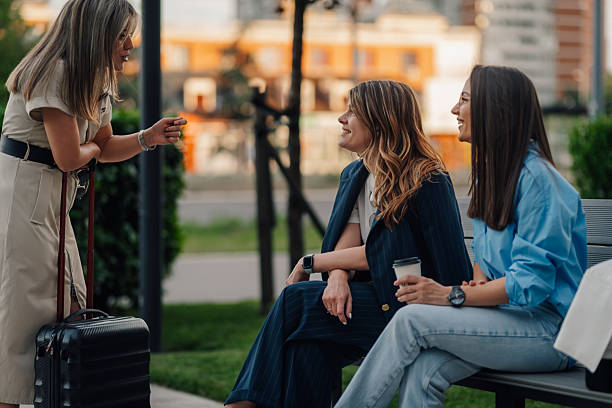 istock Businesswomen talking on a bench during coffee break 2220356744