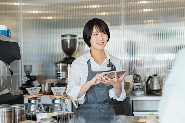 istock Female staff taking orders at a cafe 2220358429